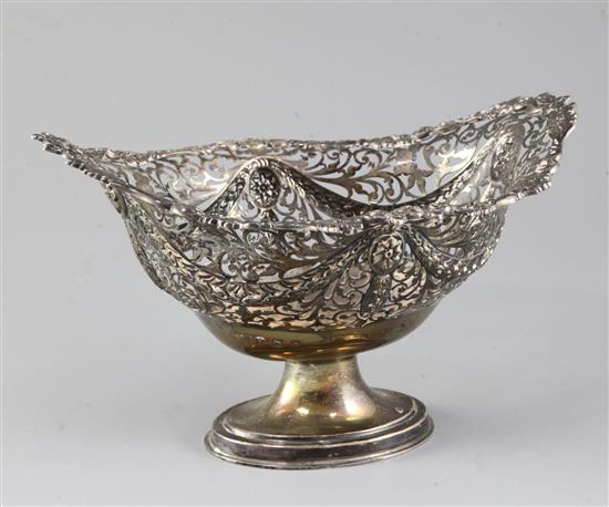 A George V pierced repousse silver oval pedestal fruit bowl, 17 oz.